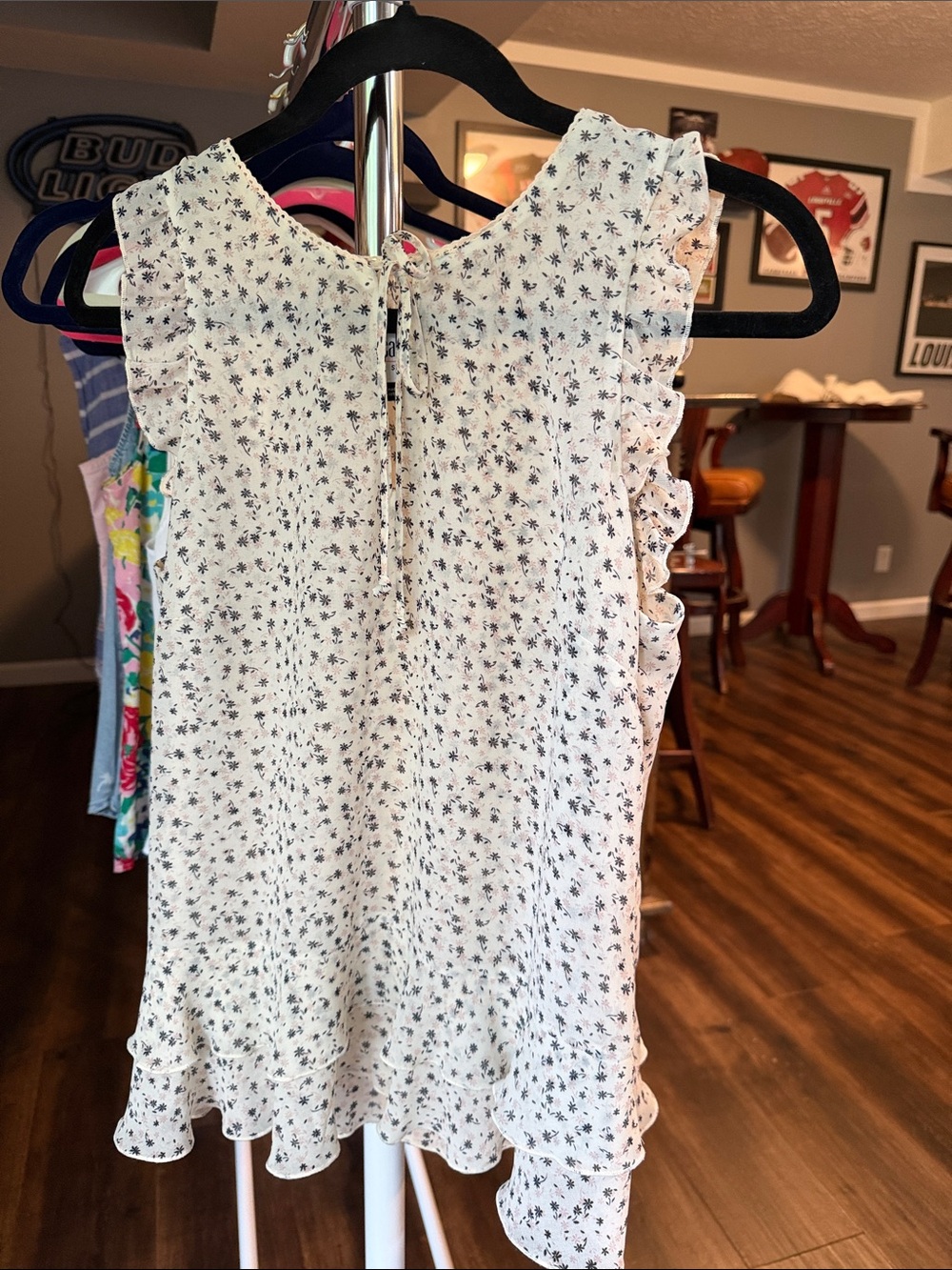 CAbi White Dress with Grey and Pink Floral Print and Ruffle Sleeves and hem.